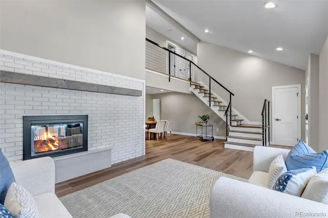 a living room with furniture and stairs