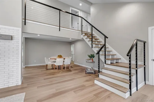 a view of entryway and hall with wooden floor