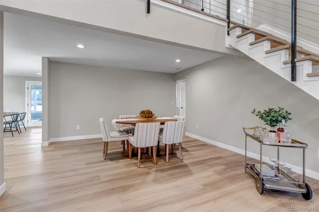 a view of a dining room with furniture and wooden floor