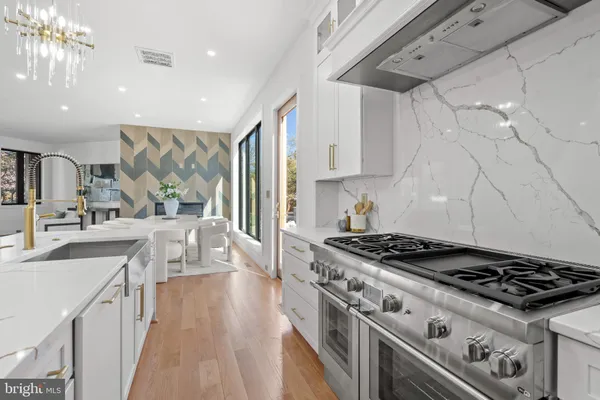 a dining room with wooden floor and a floor to ceiling window