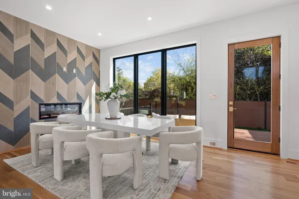 a living room with furniture and a large mirror