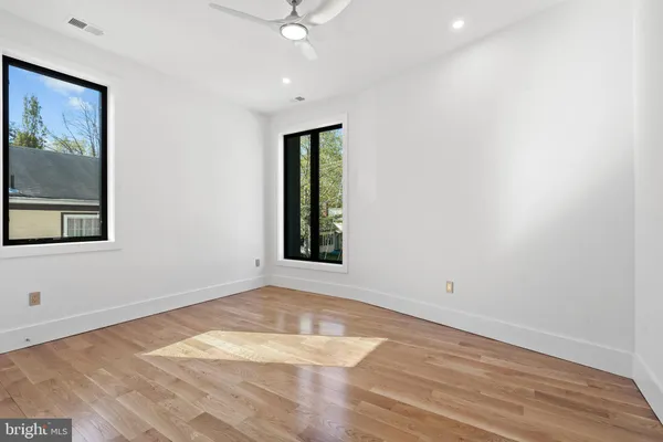 wooden floor in an empty room with a window