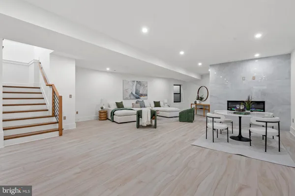 a large room with lots of furniture and a wooden floors
