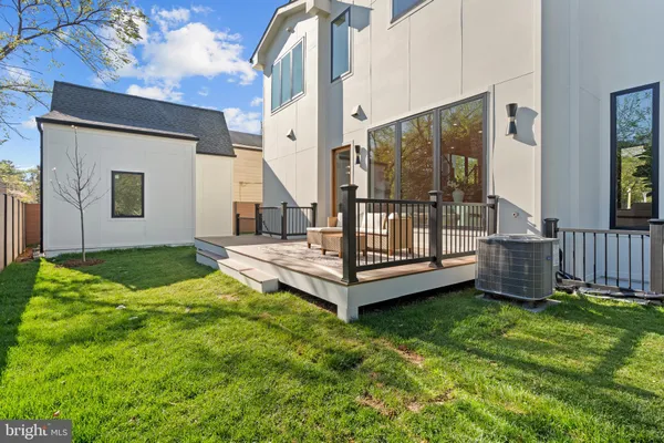 a view of a house with a big yard and large trees