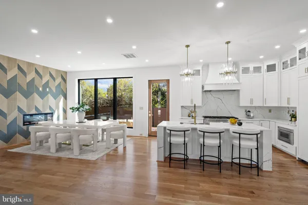 a kitchen with stainless steel appliances granite countertop a stove and white cabinets