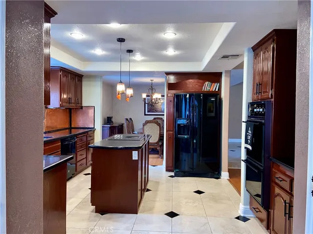 a kitchen with a refrigerator and a stove top oven