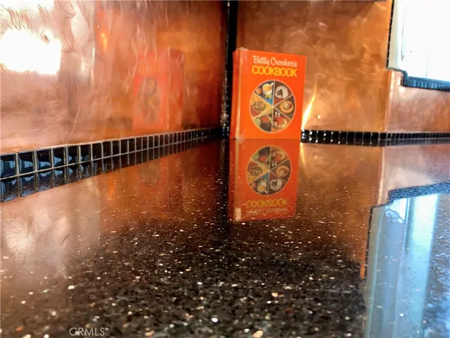 a living room with furniture a large window and a chandelier