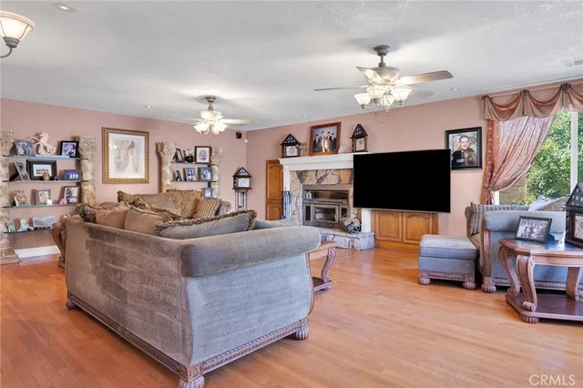 a living room with furniture a chandelier and a flat screen tv