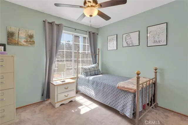 a bathroom with a sink a toilet a mirror and shower curtain