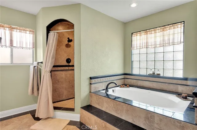 a bathroom with a tub and a view of bathroom