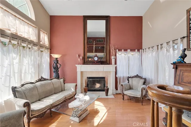 a living room with furniture a fireplace and a floor to ceiling window