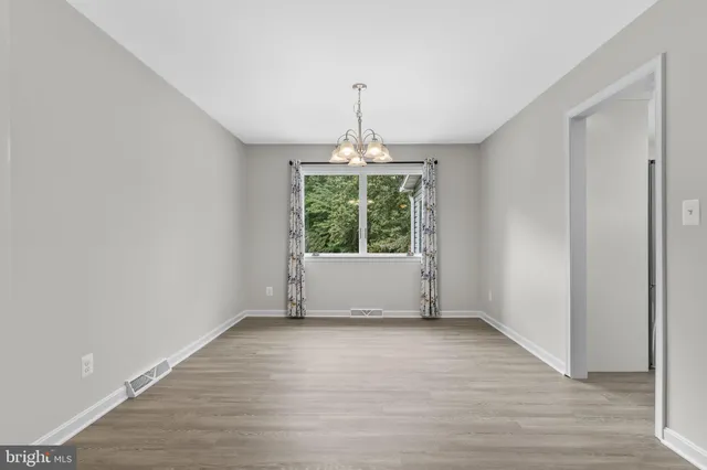 a view of a livingroom with a ceiling fan & chandelier fan