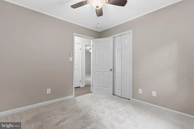 a view of a livingroom with a ceiling fan and window