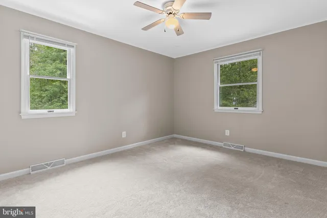 a view of an empty room with a fireplace