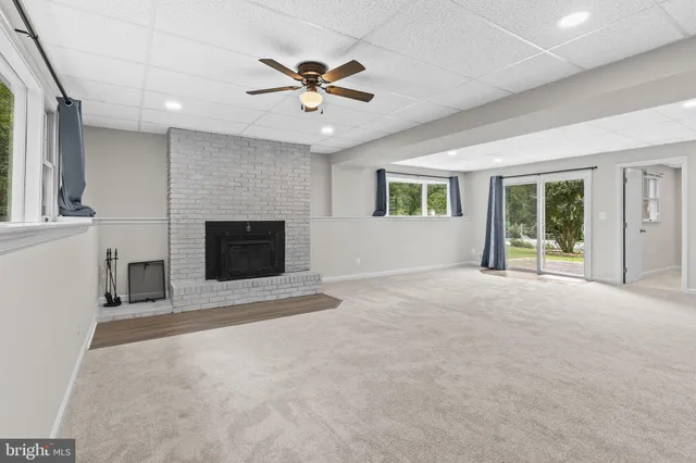 a view of a house with a backyard and a patio