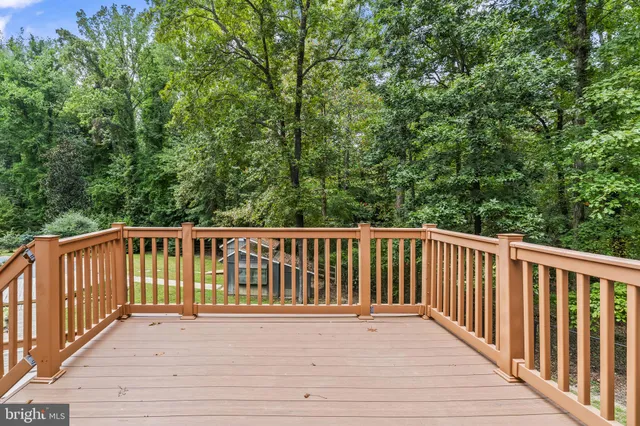 a view of a house with a yard and lawn chairs next to a yard