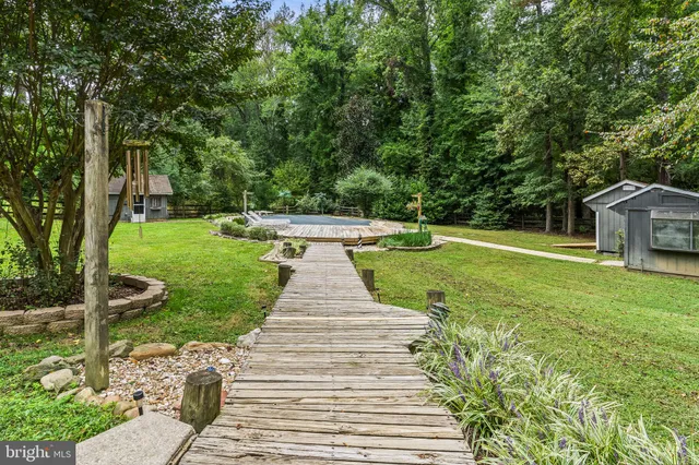 an aerial view of a house with garden space and street view