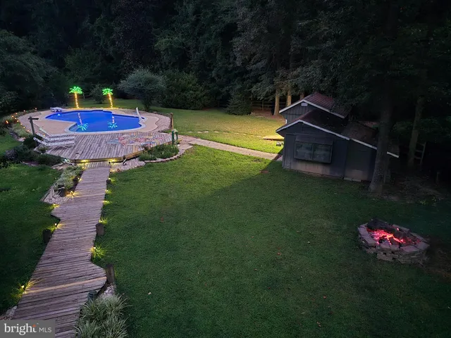 a view of a backyard with swimming pool