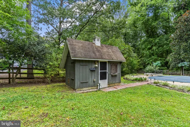 an aerial view of a house with a yard and lake view