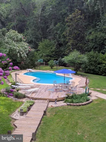 a kitchen with stainless steel appliances a sink a stove a microwave and wooden cabinets