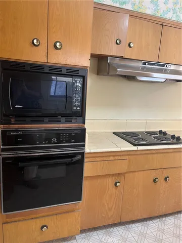 a stove top oven sitting inside of a kitchen