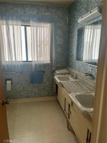 a bathroom with a granite countertop sink and a bathtub