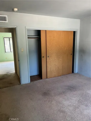 a view of an empty room with a closet