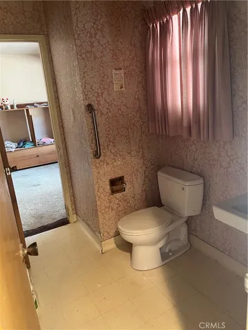 a white toilet sitting next to a bathroom sink