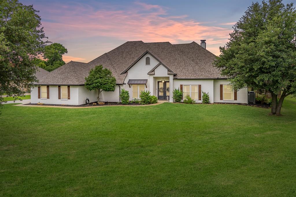 115 Pheasant Run Road Argyle, TX 76226 - Photo 1 of 40 a view of a house next to a big yard and large trees