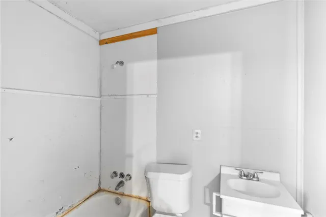 a bathroom with a toilet a sink and a shower