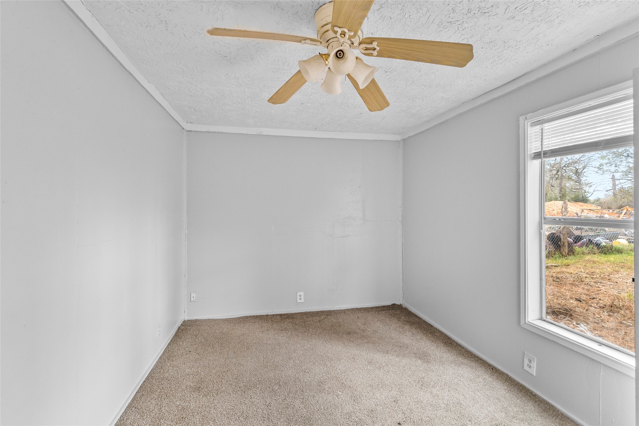 31C Jackson Road, Unit A Huntsville, TX 77320 - Photo 14 of 17 an empty room with a window and a fan