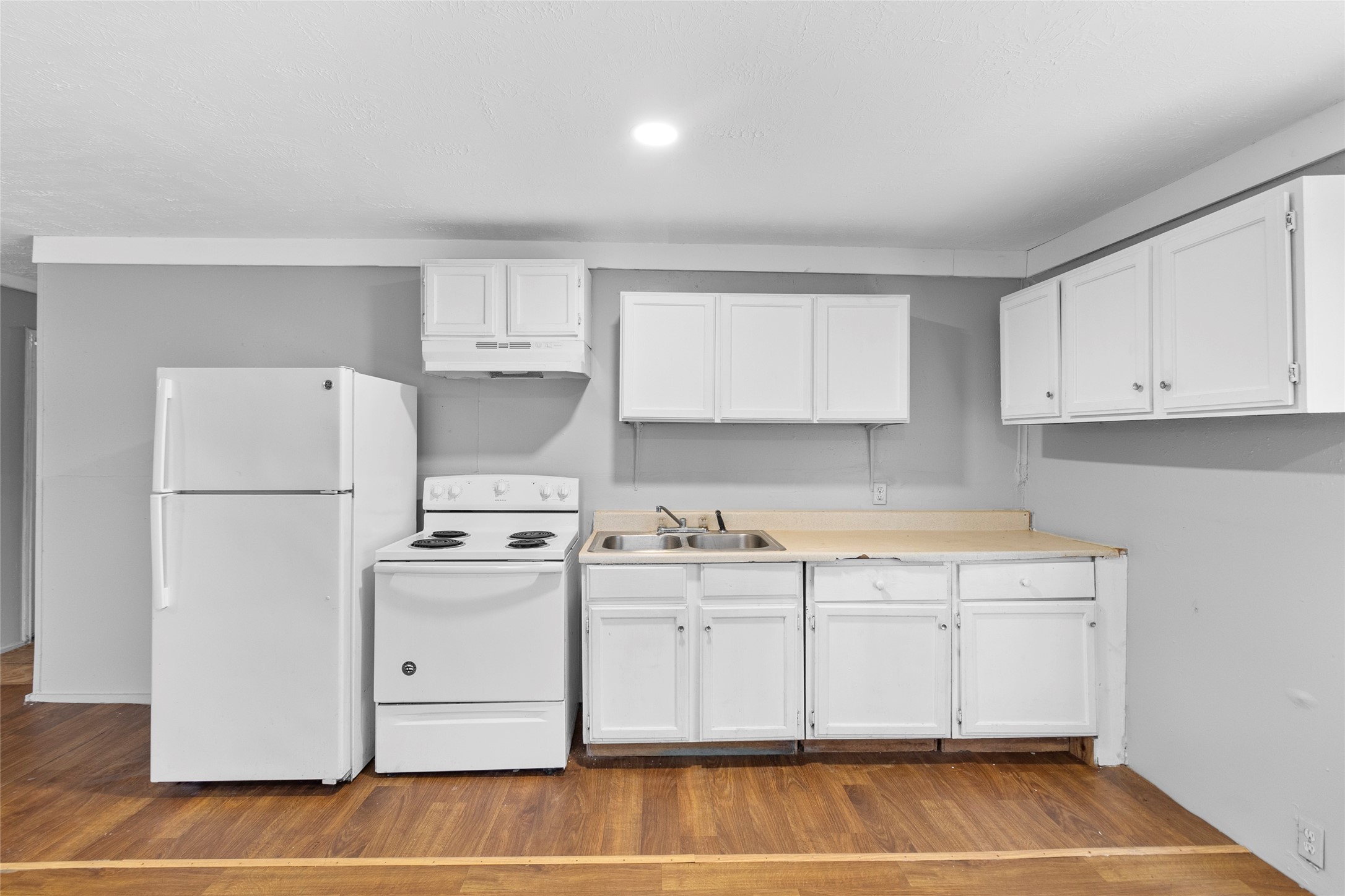 31C Jackson Road, Unit A Huntsville, TX 77320 - Photo 6 of 17 a kitchen with a white cabinets and refrigerator
