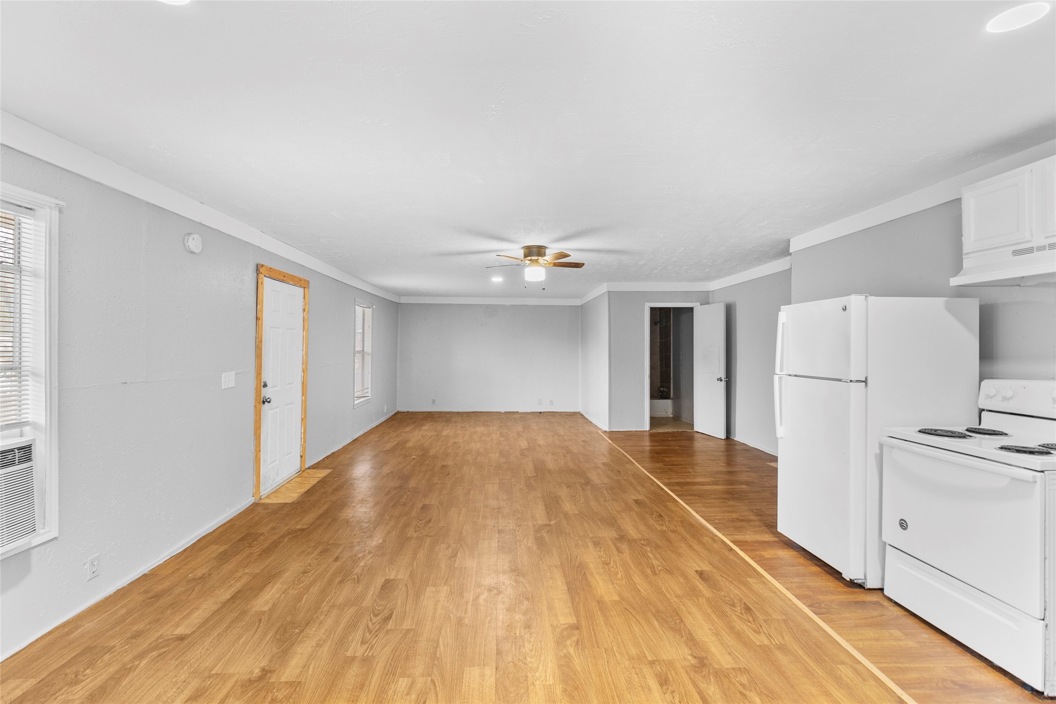 31C Jackson Road, Unit A Huntsville, TX 77320 - Photo 7 of 17 a view of empty room with wooden floor and window