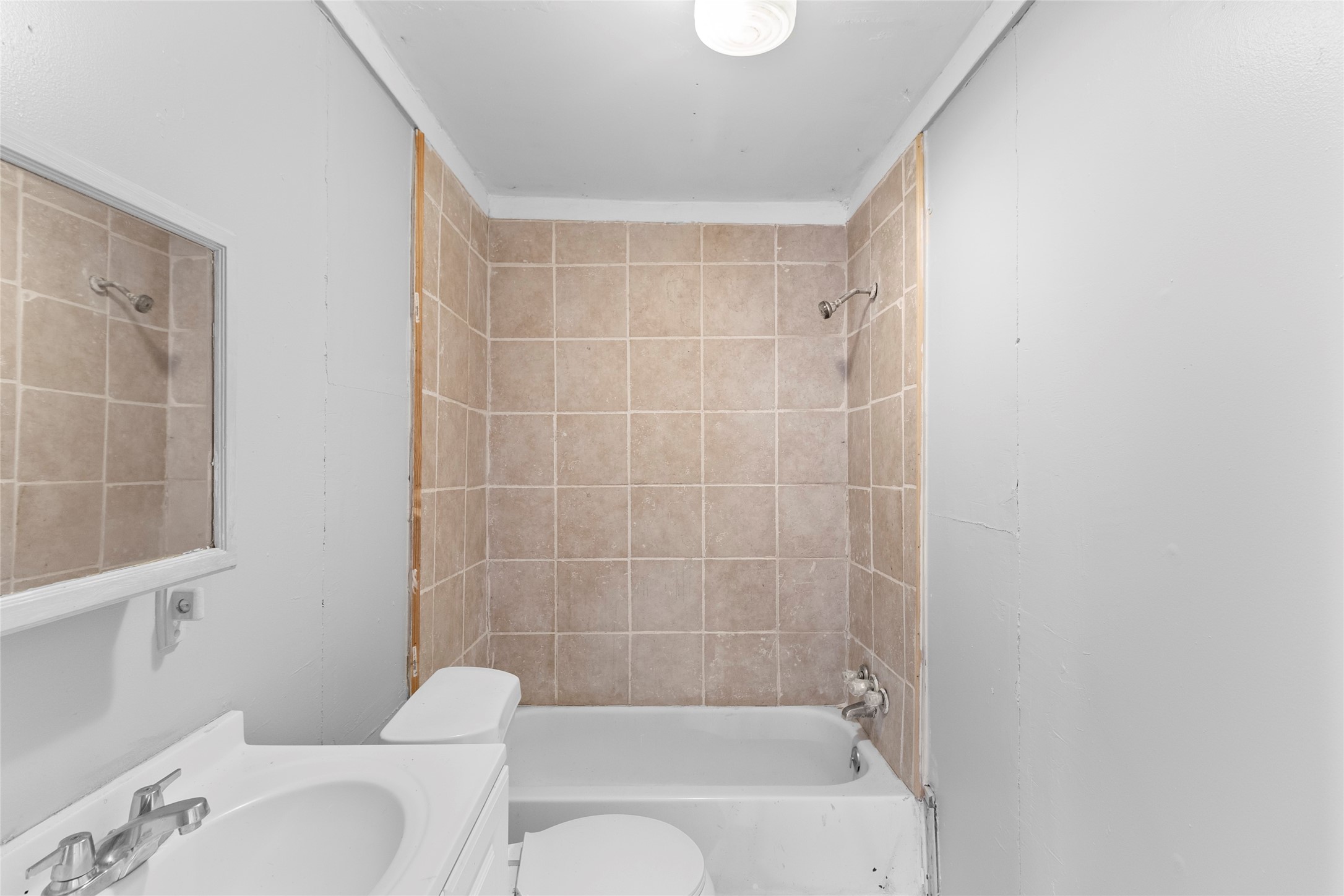 31C Jackson Road, Unit A Huntsville, TX 77320 - Photo 8 of 17 a bathroom with a bathtub shower sink vanity and toilet