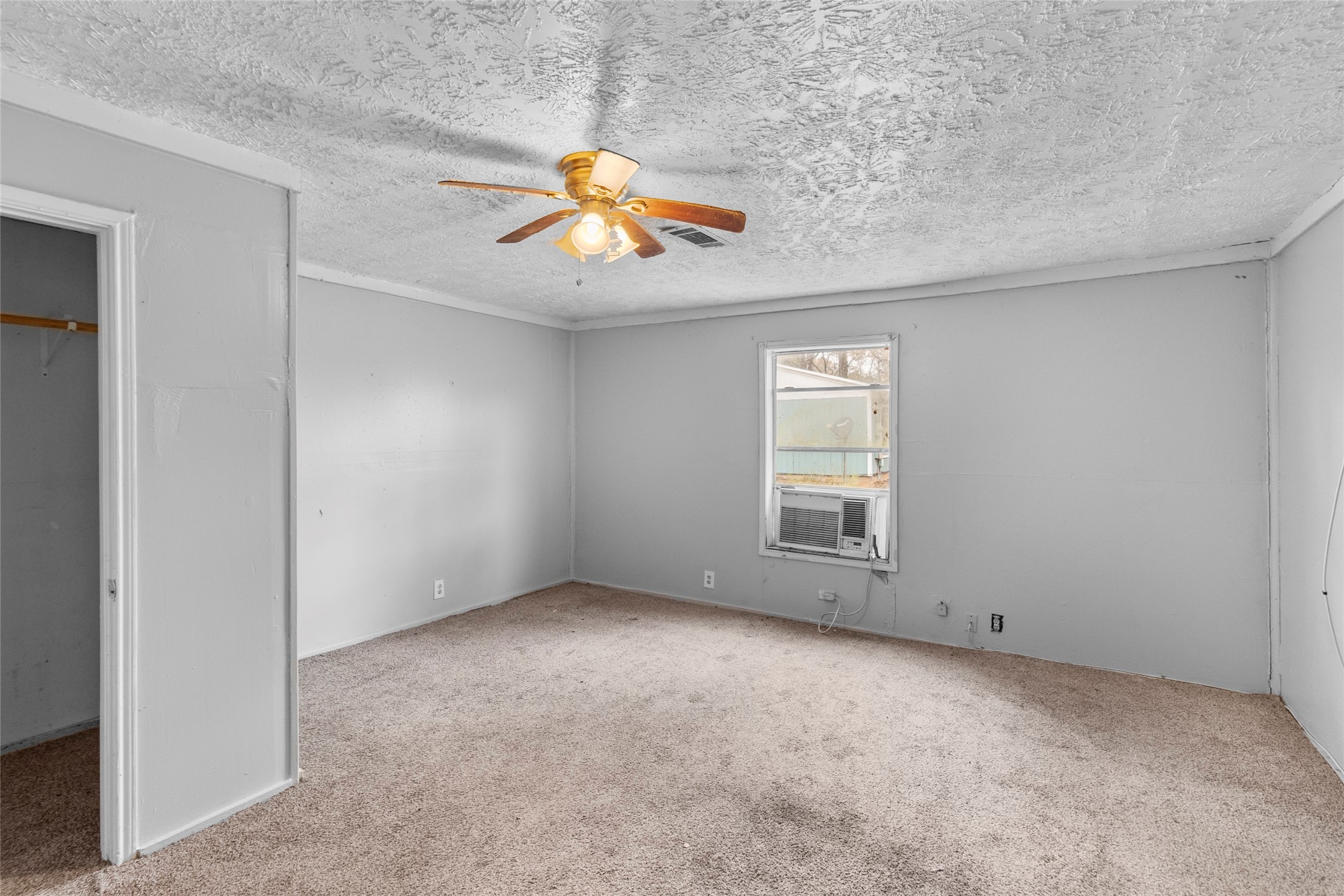 31C Jackson Road, Unit A Huntsville, TX 77320 - Photo 10 of 17 an empty room with windows and chandelier fan