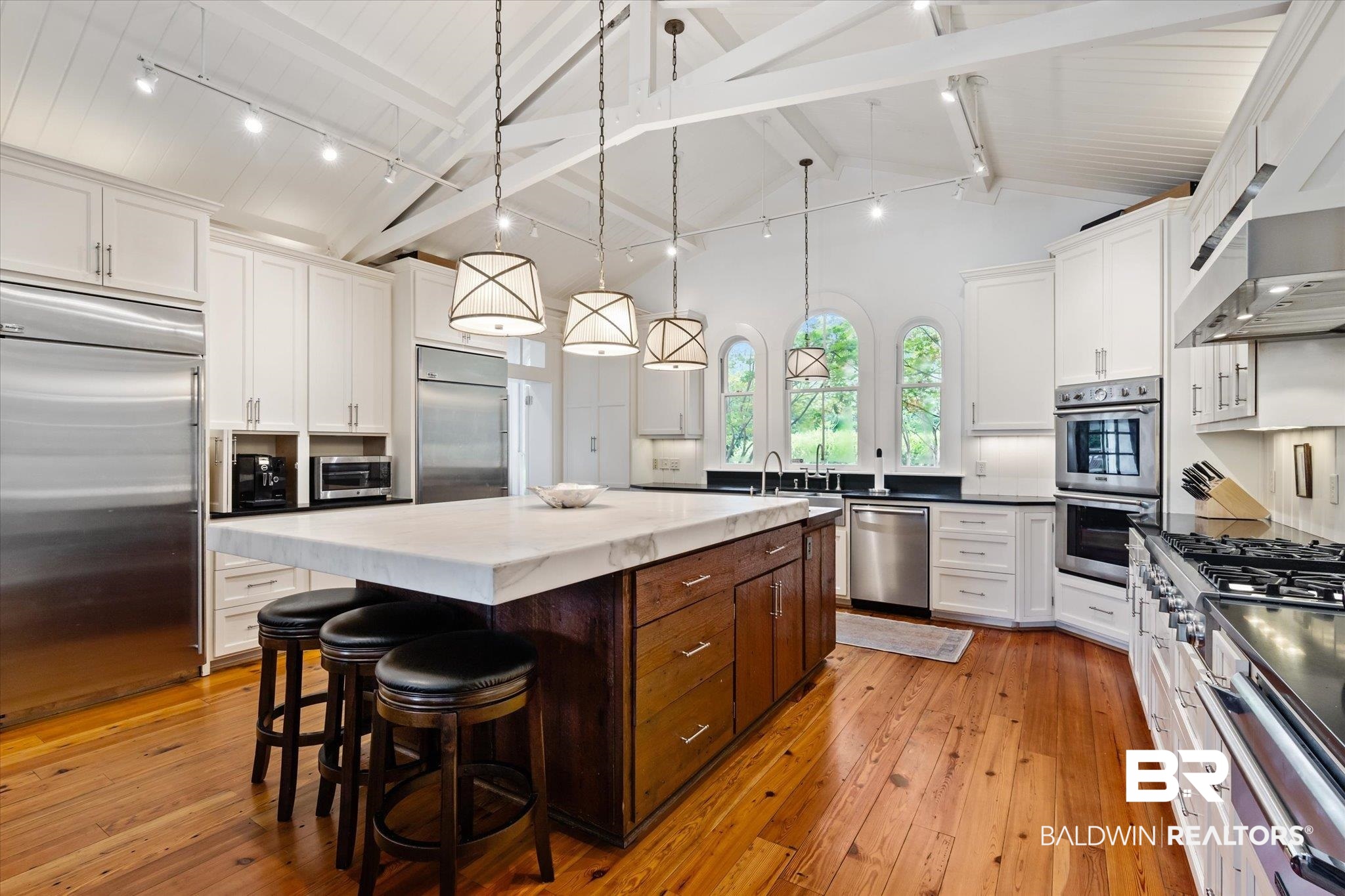 2205 Spring Hill Avenue Mobile, AL 36607 - Photo 12 of 59 Kitchen with light hardwood / wood-style flooring, rail lighting, a center island, stainless steel appliances, and decorative light fixtures