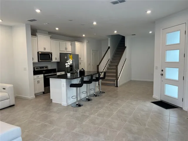 a kitchen with refrigerator and window