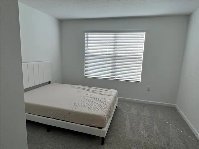 a bedroom with a bed and a walk in closet