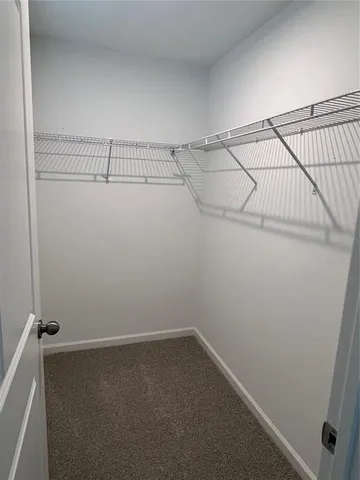 wooden floor with view of bathroom