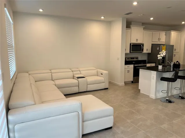 a view of kitchen with microwave and cabinets