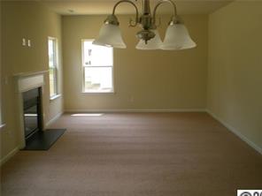 11623 Tucker Field Road Midland, NC 28107 - Photo 3 of 8 an empty room with a fireplace