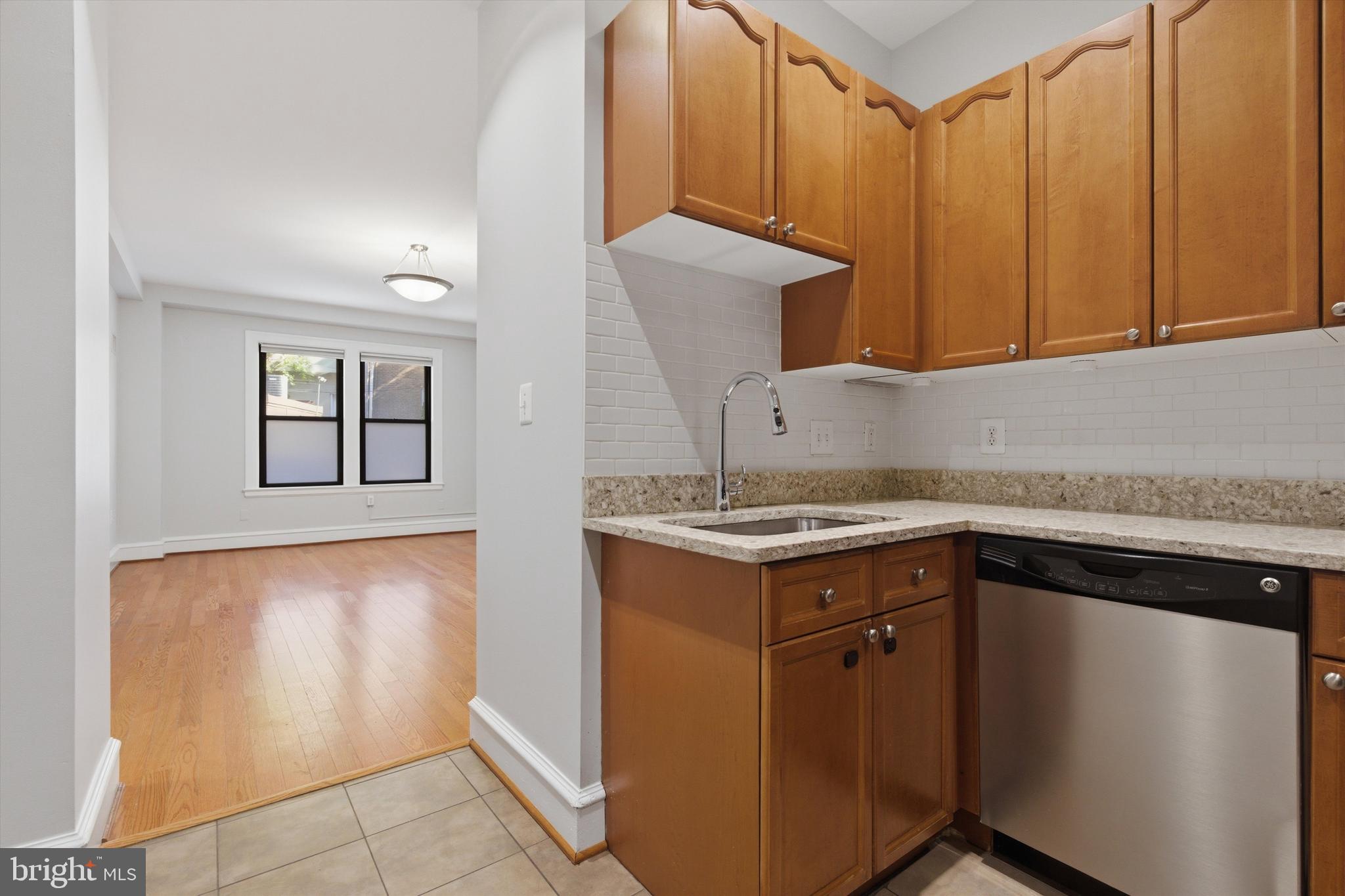 1613 Harvard Street Northwest, Unit 114 Washington, DC 20009 - Photo 7 of 22 Quartz counters and stainless steel appliances
