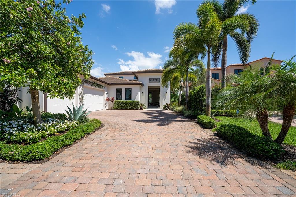 16708 Lucarno Way Naples, FL 34110 - Photo 1 of 46 a front view of a house with a garden