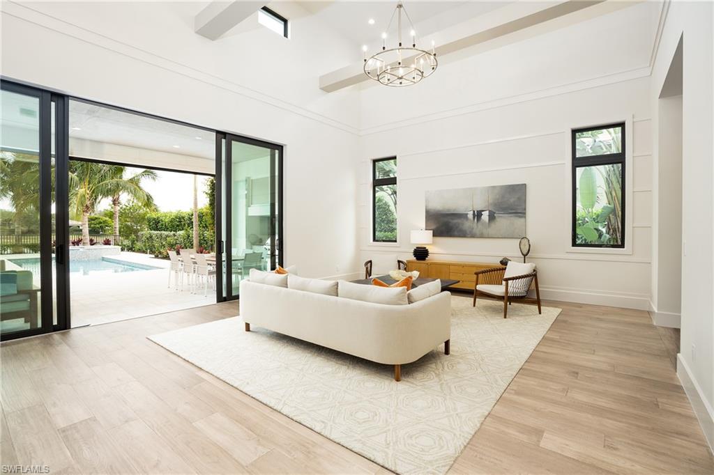 16708 Lucarno Way Naples, FL 34110 - Photo 12 of 46 a living room with furniture and a large window