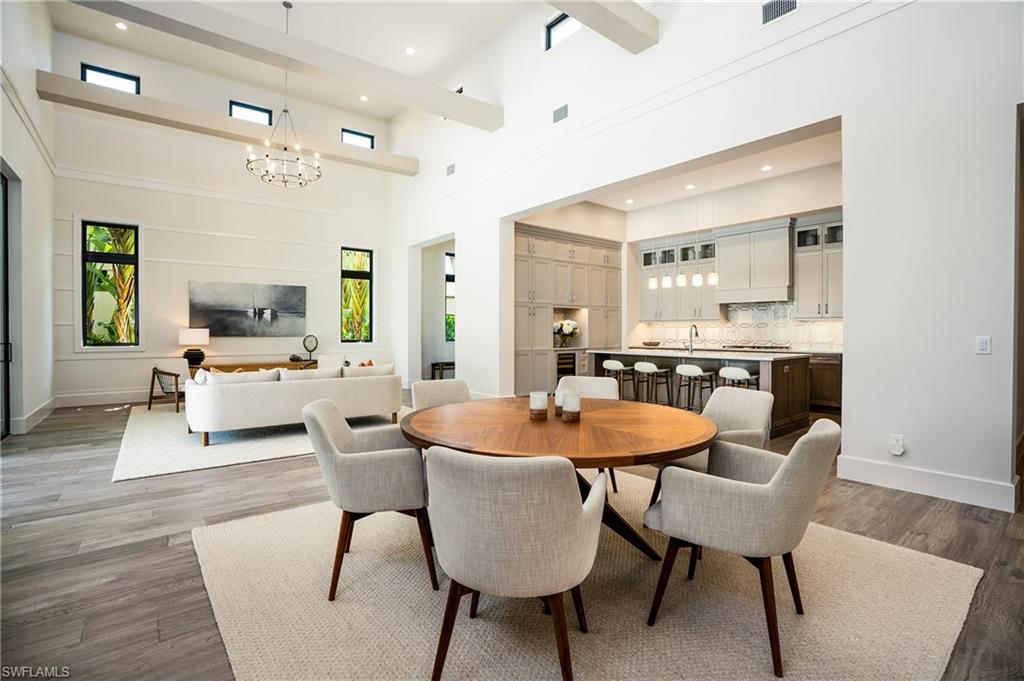 16708 Lucarno Way Naples, FL 34110 - Photo 14 of 46 a living room with furniture and a dining table