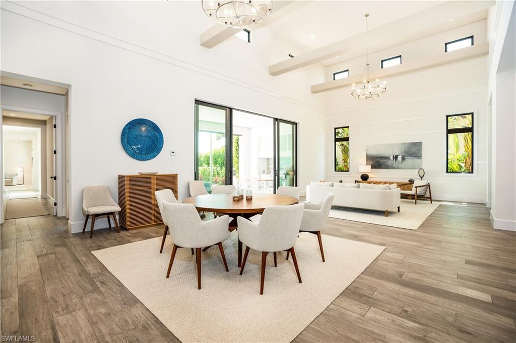 16708 Lucarno Way Naples, FL 34110 - Photo 15 of 46 a living room with furniture wooden floor and a large window