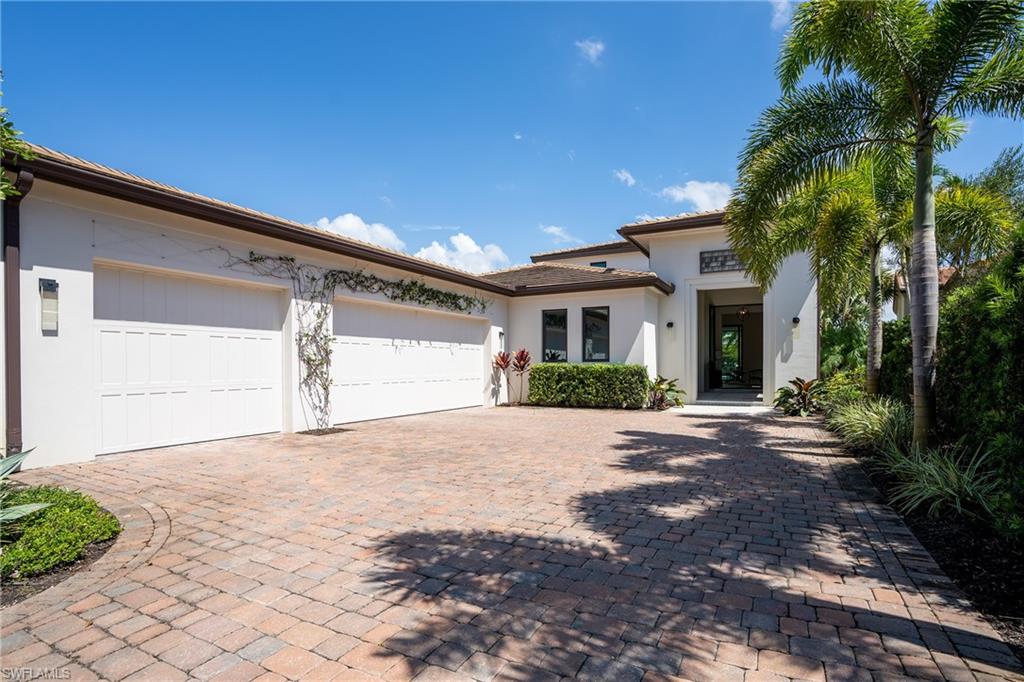 16708 Lucarno Way Naples, FL 34110 - Photo 2 of 46 a front view of a house with a yard and a garage