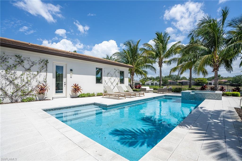 16708 Lucarno Way Naples, FL 34110 - Photo 23 of 46 a view of swimming pool with outdoor seating and house in the background