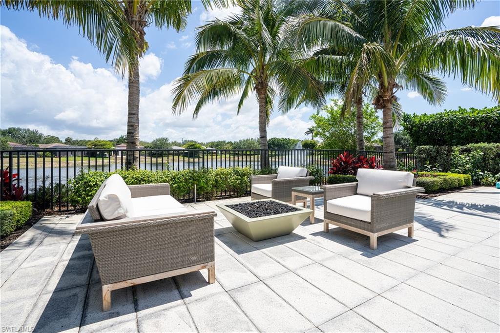 16708 Lucarno Way Naples, FL 34110 - Photo 25 of 46 a view of a patio with couches potted plants and a palm tree