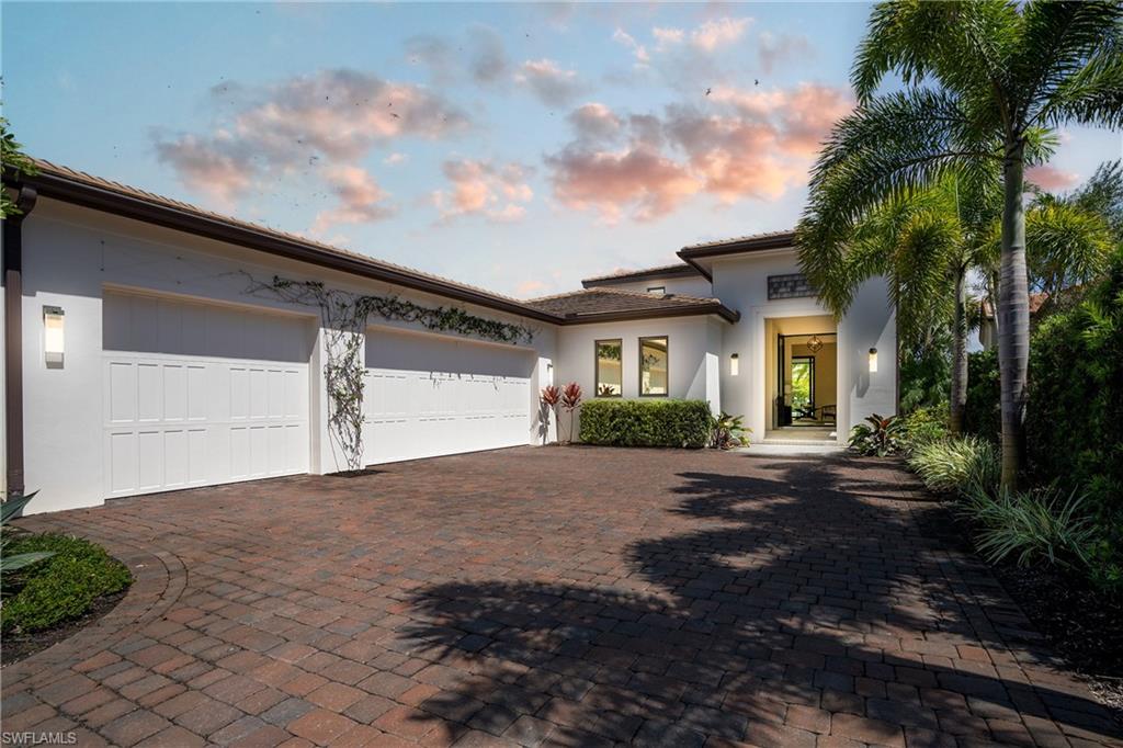 16708 Lucarno Way Naples, FL 34110 - Photo 3 of 46 a front view of a house with a yard and a garage